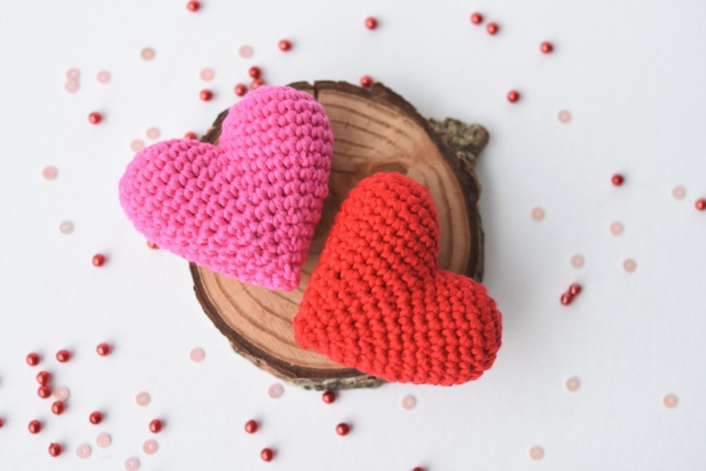 A handcrafted crochet amigurumi heart, made with soft yarn and a plush texture. This adorable heart is perfect as a gift, decoration, or keychain accessory, adding a touch of handmade charm.